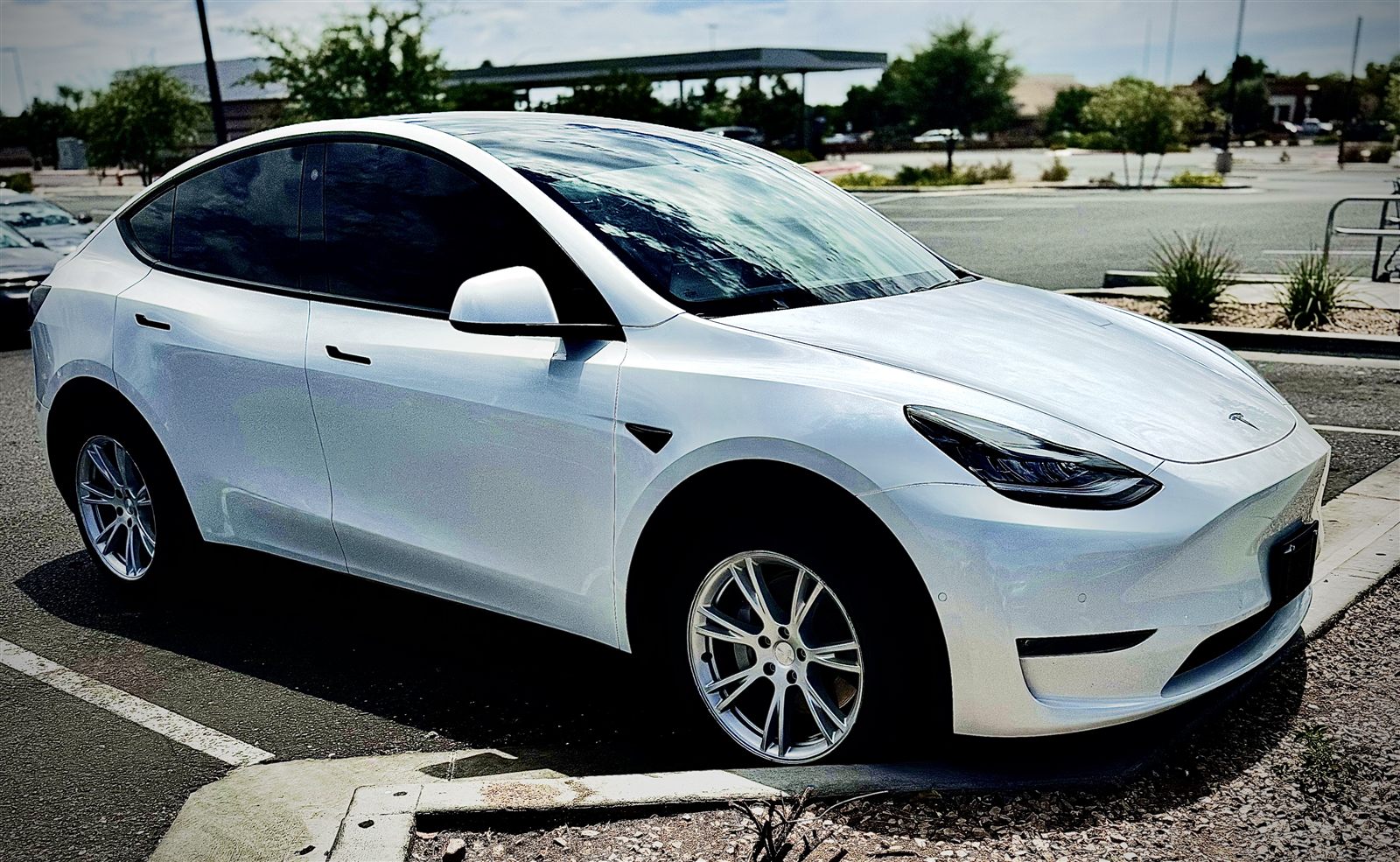 Pearl white Tesla Model Y, freshly detailed, gleaming in an Arizona parking lot